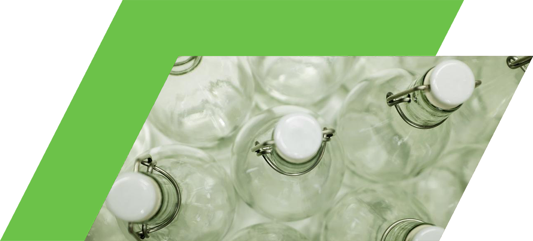 Aerial view of multiple clear glass bottles with white caps and metal clamps.