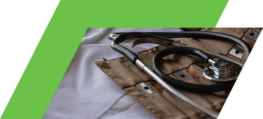 A stethoscope and blood pressure cuff resting on a white surface.